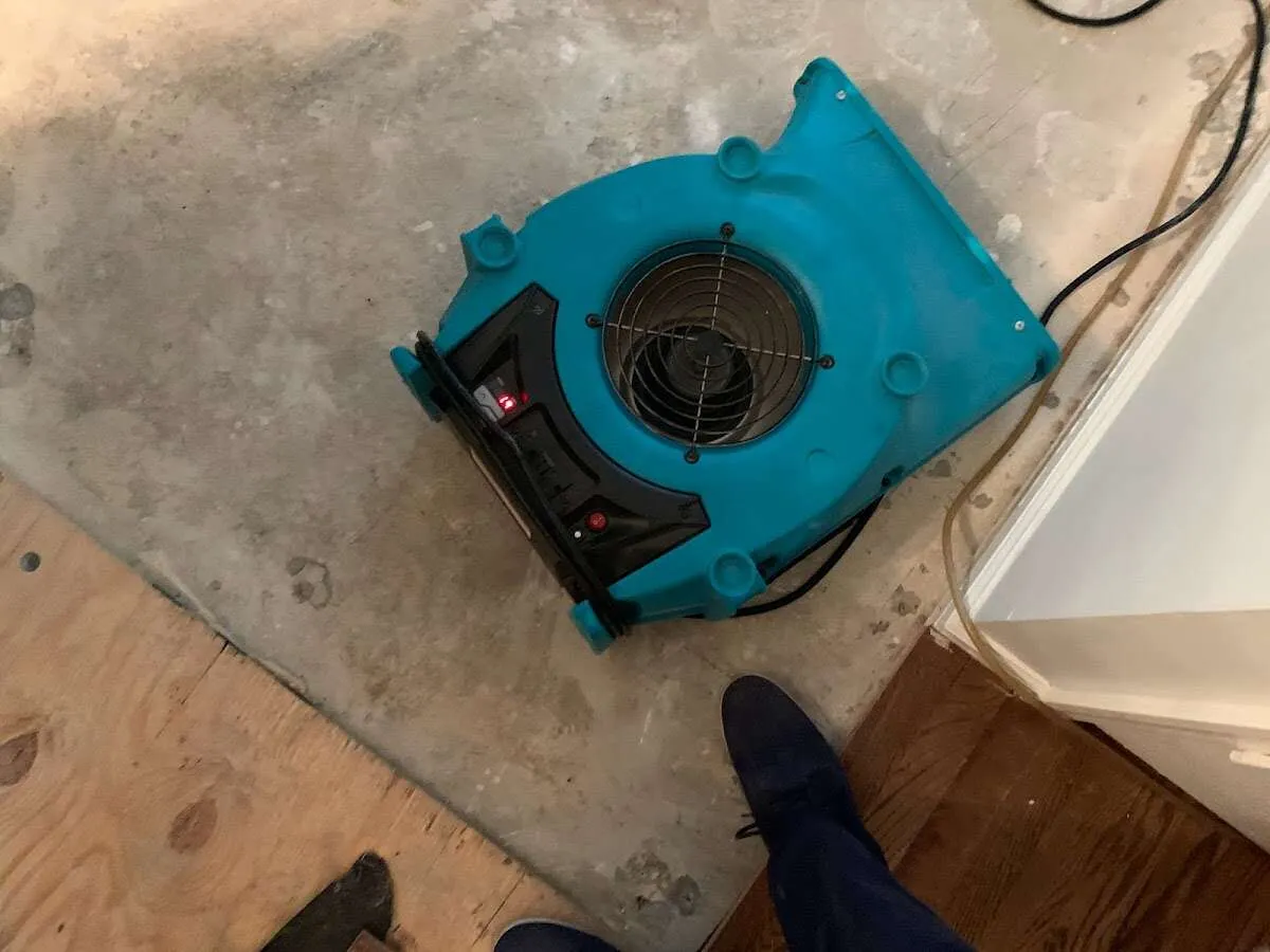 Air mover drying subfloor during Commercial Water Damage Restoration in Raritan